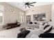 Spacious living room features carpet, a large fan, and stylish decor at 4037 E Elmwood St, Mesa, AZ 85205