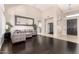 Open concept living space featuring hardwood floors and stylish gray sectional at 4037 E Elmwood St, Mesa, AZ 85205