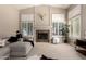 Inviting living room features a stone fireplace, neutral decor, and plantation shutters at 4037 E Elmwood St, Mesa, AZ 85205