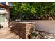 An outdoor kitchen area features a stone veneer and stainless steel sink at 4037 E Elmwood St, Mesa, AZ 85205