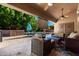 Outdoor patio with comfortable seating, a built-in grill area, and a projection screen for entertainment at 4037 E Elmwood St, Mesa, AZ 85205