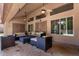 Covered patio features comfortable seating, ceiling fans, and views of the beautifully landscaped backyard at 4037 E Elmwood St, Mesa, AZ 85205