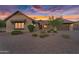 Charming single-story home featuring low-maintenance landscaping and a warm, inviting facade at sunset at 42161 N Via Cienna --, San Tan Valley, AZ 85140