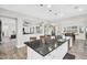 Spacious kitchen island with a dark countertop, white cabinetry, and pendant lighting at 42161 N Via Cienna --, San Tan Valley, AZ 85140