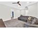 Spacious living room with gray sectional couch, neutral walls, and access to the upstairs landing at 42161 N Via Cienna --, San Tan Valley, AZ 85140