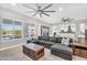 Bright and spacious living room with a ceiling fan, tile flooring and a sectional sofa at 42161 N Via Cienna --, San Tan Valley, AZ 85140