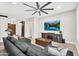 Comfortable living room featuring a ceiling fan, tile flooring, and a sectional sofa at 42161 N Via Cienna --, San Tan Valley, AZ 85140