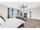 A calming main bedroom boasts a ceiling fan and comfortable seating area at 42161 N Via Cienna --, San Tan Valley, AZ 85140