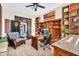 Bright office boasts a large desk, custom shelving, and unique decor, enhanced by a ceiling fan at 42161 N Via Cienna --, San Tan Valley, AZ 85140