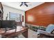 Comfortable office with dark wood desk, wood-paneled wall and natural light from large window at 42161 N Via Cienna --, San Tan Valley, AZ 85140