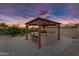 Outdoor kitchen under a lighted gazebo, has built in seating and grill for backyard entertainment at 42161 N Via Cienna --, San Tan Valley, AZ 85140