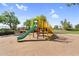 Community playground featuring a slide, climbing structure, and lush landscaping at 42161 N Via Cienna --, San Tan Valley, AZ 85140