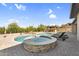 Beautiful backyard oasis featuring a large pool, hot tub, covered outdoor kitchen and lounge chairs at 42161 N Via Cienna --, San Tan Valley, AZ 85140