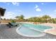 Backyard swimming pool with spa, rock waterfall feature and beautiful desert landscaping at 42161 N Via Cienna --, San Tan Valley, AZ 85140