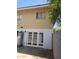 View of back exterior of home, featuring white painted brick, double doors, and partial fencing at 4533 N 17Th Ave, Phoenix, AZ 85015