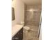 Well-lit bathroom with dark vanity and tiled shower at 4533 N 17Th Ave, Phoenix, AZ 85015