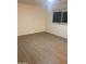 Clean and bright bedroom with wood-style flooring and window at 4533 N 17Th Ave, Phoenix, AZ 85015