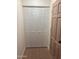 Hallway featuring bi-fold closet doors and tan interior door, with wood flooring at 4533 N 17Th Ave, Phoenix, AZ 85015