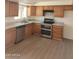 Bright kitchen with stainless steel appliances, granite countertops, and wood-look flooring at 4533 N 17Th Ave, Phoenix, AZ 85015