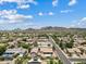 Panoramic aerial showcasing neighborhood, desert landscape, and mountain views at 4701 W Fallen Leaf Ln, Glendale, AZ 85310