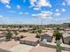 Aerial view of a single-story home with a three-car garage and a detached garage nestled in a residential community at 4701 W Fallen Leaf Ln, Glendale, AZ 85310