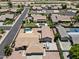 Aerial view showcasing a home with a private pool and detached garage in a well-maintained neighborhood at 4701 W Fallen Leaf Ln, Glendale, AZ 85310