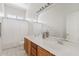 Well-lit bathroom with double sinks and neutral finishes at 4701 W Fallen Leaf Ln, Glendale, AZ 85310