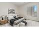 Sleek bedroom with a modern bed, side tables, contemporary art, and a view of the entrance at 4701 W Fallen Leaf Ln, Glendale, AZ 85310