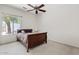 Cozy bedroom with a ceiling fan, a plush bed, and natural light from a window at 4701 W Fallen Leaf Ln, Glendale, AZ 85310