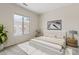 Calm bedroom showcasing neutral tones, natural light from the window, and minimalist decor at 4701 W Fallen Leaf Ln, Glendale, AZ 85310