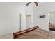 Bright bedroom featuring a ceiling fan and access to an adjoining bathroom at 4701 W Fallen Leaf Ln, Glendale, AZ 85310