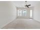 Bedroom with plush neutral carpet, a decorative ceiling fan, and large windows at 4701 W Fallen Leaf Ln, Glendale, AZ 85310