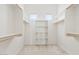 Walk-in closet featuring built-in shelving and wood-finish rods at 4701 W Fallen Leaf Ln, Glendale, AZ 85310