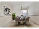 Cozy dining room with wainscoting, art, a round table with seating for four, and decorative chandelier at 4701 W Fallen Leaf Ln, Glendale, AZ 85310