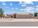 Charming single-story home boasting a three-car garage and low-maintenance desert landscaping on a sunny day at 4701 W Fallen Leaf Ln, Glendale, AZ 85310