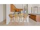 Kitchen featuring wood cabinets, granite countertops, stainless appliances, and a breakfast bar at 4701 W Fallen Leaf Ln, Glendale, AZ 85310