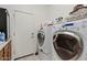 Well-equipped laundry room with modern washer and dryer, and storage area at 4701 W Fallen Leaf Ln, Glendale, AZ 85310