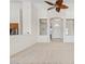 Open-concept living room with light neutral carpet and an archway entrance at 4701 W Fallen Leaf Ln, Glendale, AZ 85310