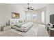 Bright main bedroom featuring high ceilings, a ceiling fan, and ample natural light from the large windows at 4701 W Fallen Leaf Ln, Glendale, AZ 85310