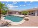 Secluded backyard with a sparkling pool, tropical palm trees, and a spacious patio, great for outdoor entertaining at 4701 W Fallen Leaf Ln, Glendale, AZ 85310