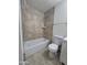 Well-lit bathroom featuring a combined shower and tub with decorative tile surround at 4911 W Merrell St, Phoenix, AZ 85031