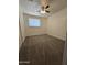 Bedroom features neutral carpet, bright lighting, and ample natural light at 4911 W Merrell St, Phoenix, AZ 85031