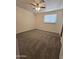 Bright bedroom with neutral carpet, ceiling fan and a window providing natural light at 4911 W Merrell St, Phoenix, AZ 85031