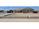 Modest single-story house featuring a neutral exterior, gravel yard, and classic desert landscaping at 4911 W Merrell St, Phoenix, AZ 85031