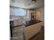 Bright kitchen with white cabinetry, stone countertops, an island, and stainless steel refrigerator at 4911 W Merrell St, Phoenix, AZ 85031
