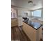 Modern kitchen with white cabinets, black countertops, and stainless steel appliances at 4911 W Merrell St, Phoenix, AZ 85031