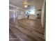 Spacious living area with stylish floors and a view into the adjacent kitchen at 4911 W Merrell St, Phoenix, AZ 85031