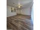 Open-concept living area with sleek wood flooring and ample natural light at 4911 W Merrell St, Phoenix, AZ 85031