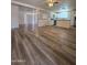 Open floor plan showcasing new wood floors connecting the living room to the kitchen and dining areas at 4911 W Merrell St, Phoenix, AZ 85031