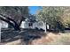 Exterior view showcasing white stucco home with mature trees and window with shutters at 498 W Gail Dr, Chandler, AZ 85225